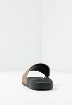 Coach UDELE SPORT SLIDE SIGNATURE COATED - Mules - Tan -Coach Shop 82ae1aac0af8481aa4c48209c3dec829